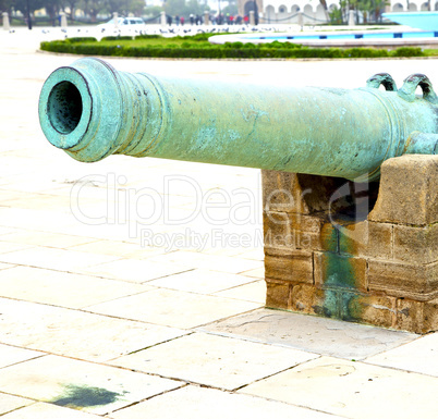 bronze cannon in africa morocco  green  and the old pavement