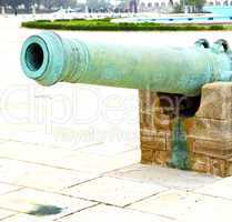 bronze cannon in africa morocco  green  and the old pavement
