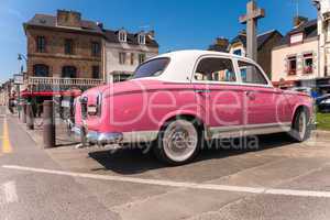 CANCALE, FRANCE - JUNE 23, 2014: Pink vintage car on the coastal