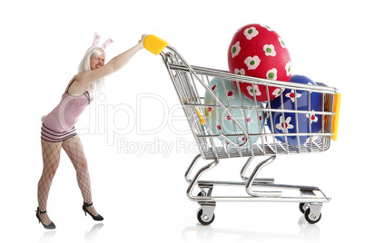 Easter bunny with colorful eggs in her shopping cart