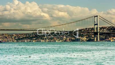 Time Lapse Photography clouds moving across the blue sky with Bosphorus Bridge