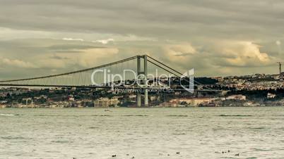 Time Lapse Photography clouds moving across the blue sky with Bosphorus Bridge