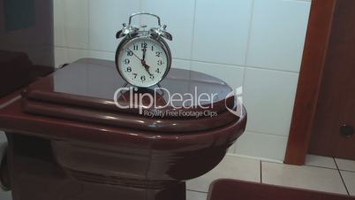 Alarm Clock on the Toilet Bowl