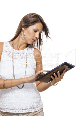 Woman chatting on a mobile while reading a tablet