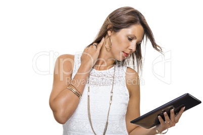 Woman chatting on a mobile while reading a tablet