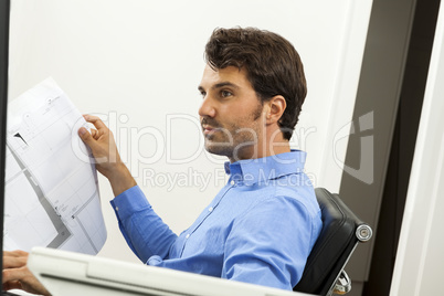 Young man reading written agreements for work