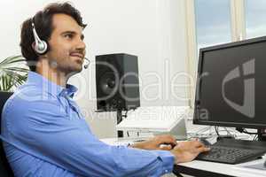 Man wearing headset giving online chat and support