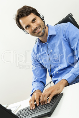 Man wearing headset giving online chat and support
