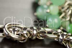 Green beads on an item of silver jewellery