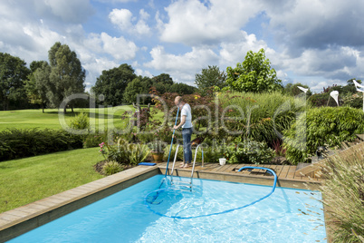 Man Cleaning Swimming Pool
