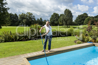 Man Cleaning Swimming Pool
