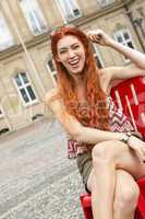 Pretty Blond Woman Sitting on Red Chair