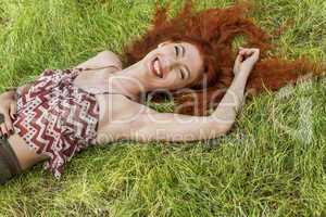 Happy Woman Lying on Grassy Ground