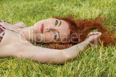 Happy Woman Lying on Grassy Ground