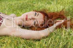 Happy Woman Lying on Grassy Ground