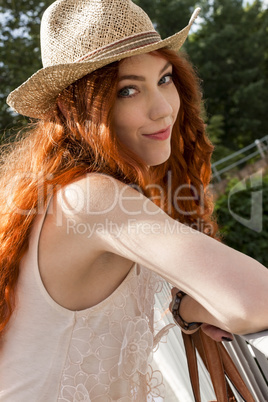 Gorgeous Woman in Hat on Cloudy Sky background