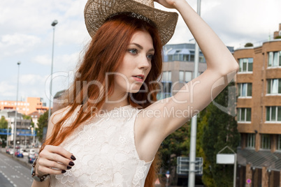 Gorgeous Woman in Hat on Cloudy Sky background