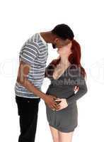 Pregnant woman kissing husband.