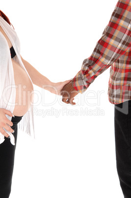 Pregnant couple holding hands.