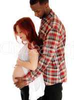 Pregnant couple holding belly.