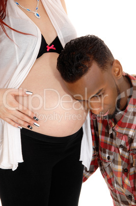 Man listening on baby belly.