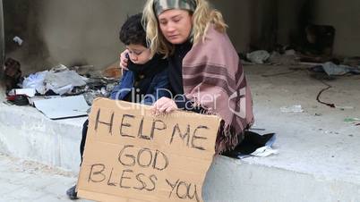 Homeless mother with her son begging