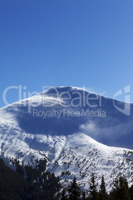 Winter mountains at sun windy day