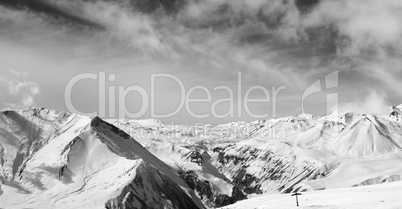 Black and white panorama of winter snowy mountains