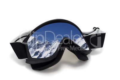 Ski goggles with reflection of snowy mountains