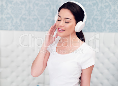 Pretty Woman Enjoying Music Using Headphones