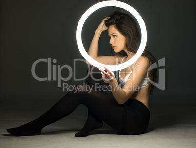 Woman in Bra and Tights Holding Circle Fluorescent