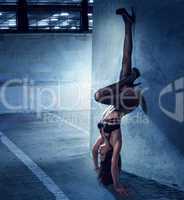 Woman in Lingerie in Upside Down Leaning on Wall