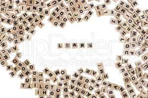learn written in small wooden cubes