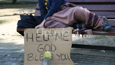 Homeless, sick child lying on bench