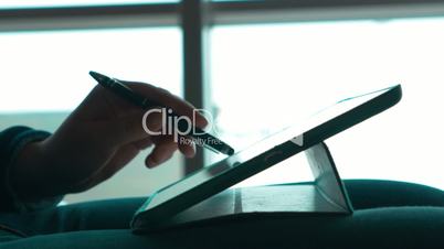Woman using pen to work with touch pad