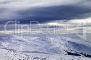 Winter mountains and storm sky