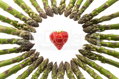 Circle Of Asparagus Tips Pointing At Strawberry.