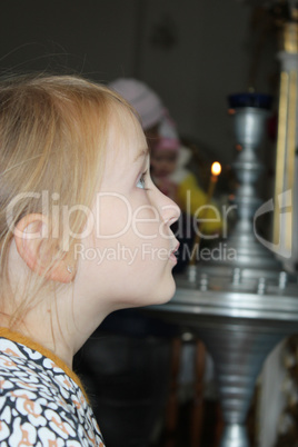 Little girl praying in the church