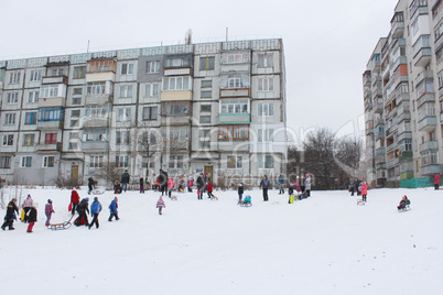 children are sleding from the hill