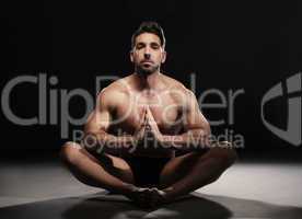 Topless Muscular Man Sitting in a Yoga Position