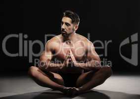 Topless Muscular Man Sitting in a Yoga Position