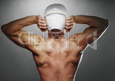 Back View of Muscular Man with Cap and Headphones