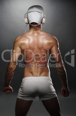 Back View of Muscular Man with Cap and Headphones