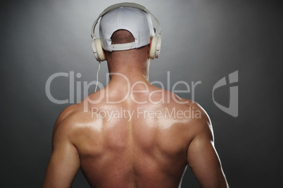 Back View of Muscular Man with Cap and Headphones
