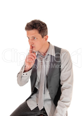 Man with finger over mouth.