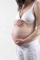 Pregnant woman in front of a white background