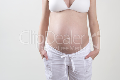 Pregnant woman in front of a white background