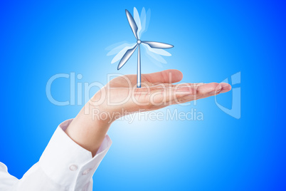 Wind Turbine Turning In A Palm On Blue Background