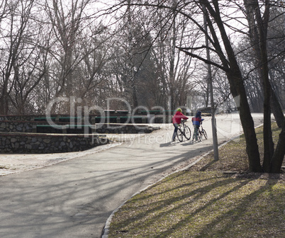 Kids boys walking with a bike in the park photo