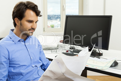 Young man reading written agreements for work